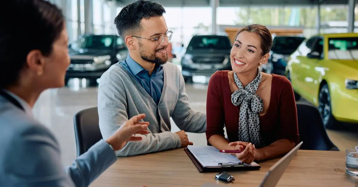 couple at an automotive sales desk